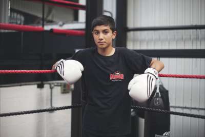 Image of Young boy, white boxing gloves