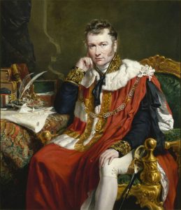 a portrait of a man seated in ceremonial dress