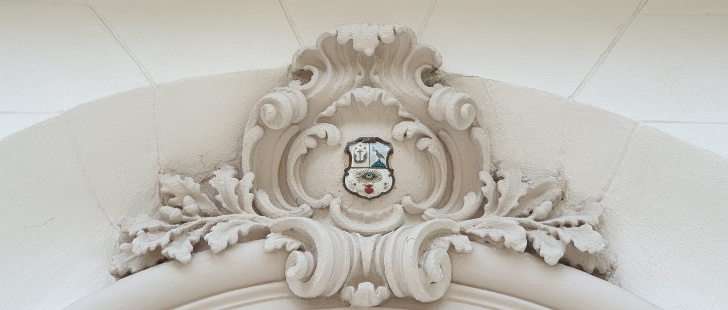 a family crest on a lintel on the exterior of the British Residence in Budapest