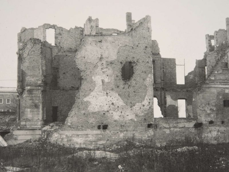 A black-and-white photographs showing the rubble of the destroyed British Embassy in 1954