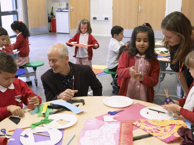 Artist David Leapman looking at artworks made by school children