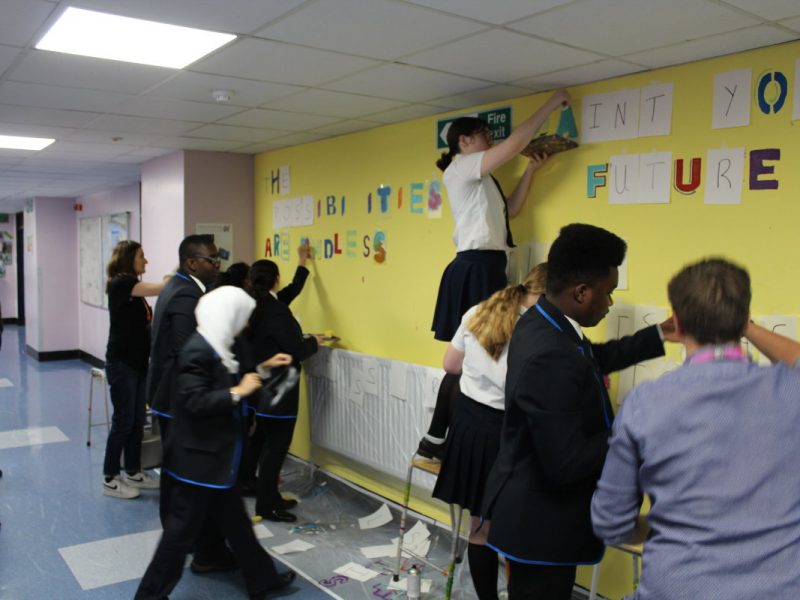 students making a mural in a school